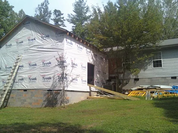 Tyvek wrapped gable on a new room addition beside an existing home in Lawrence